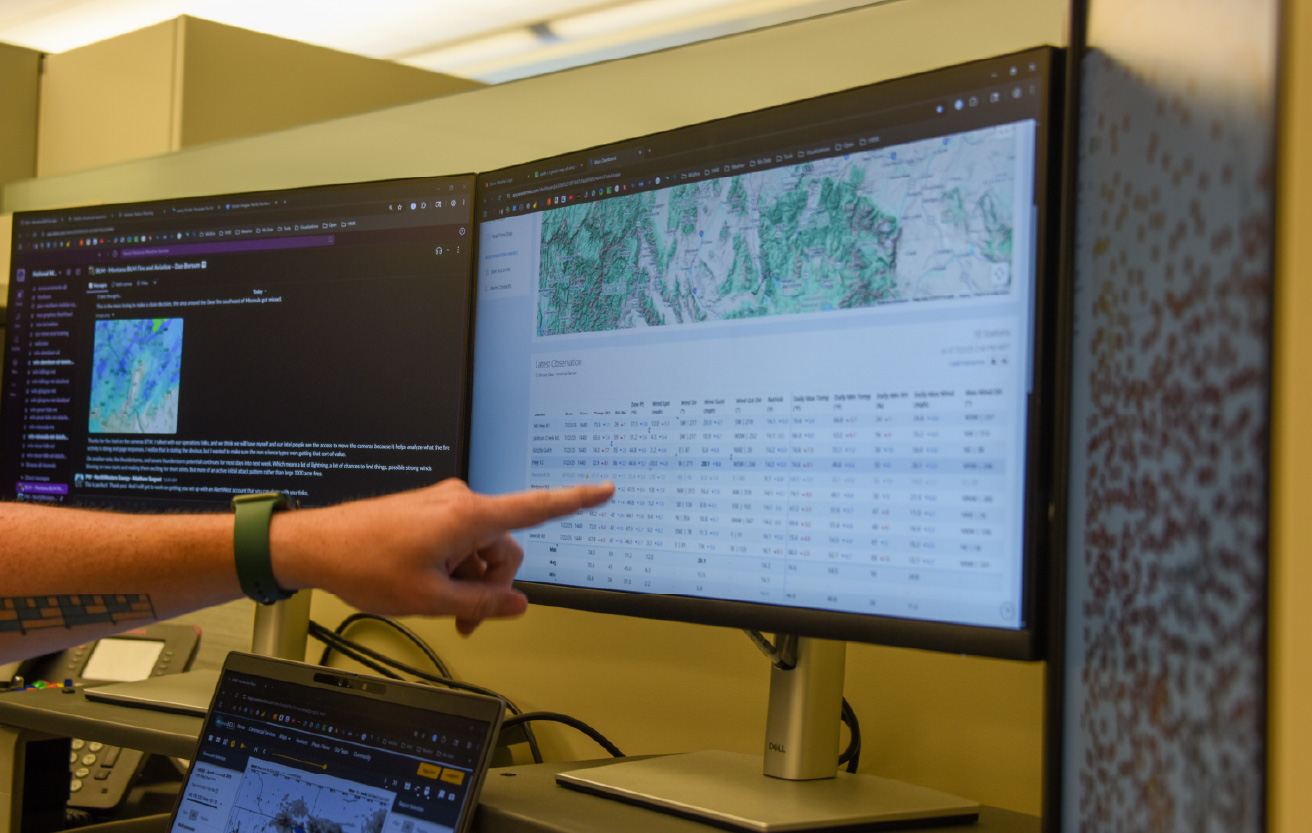 Meteorologist Matt Sargent points at his computer screen